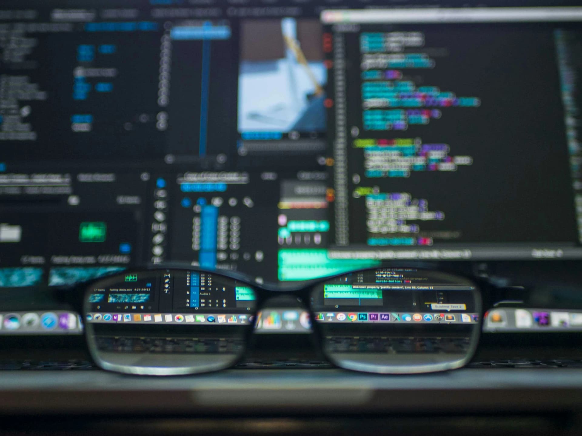 Cybersecurity analyst reviewing AI-generated threat alerts on a security dashboard, representing the human in the loop