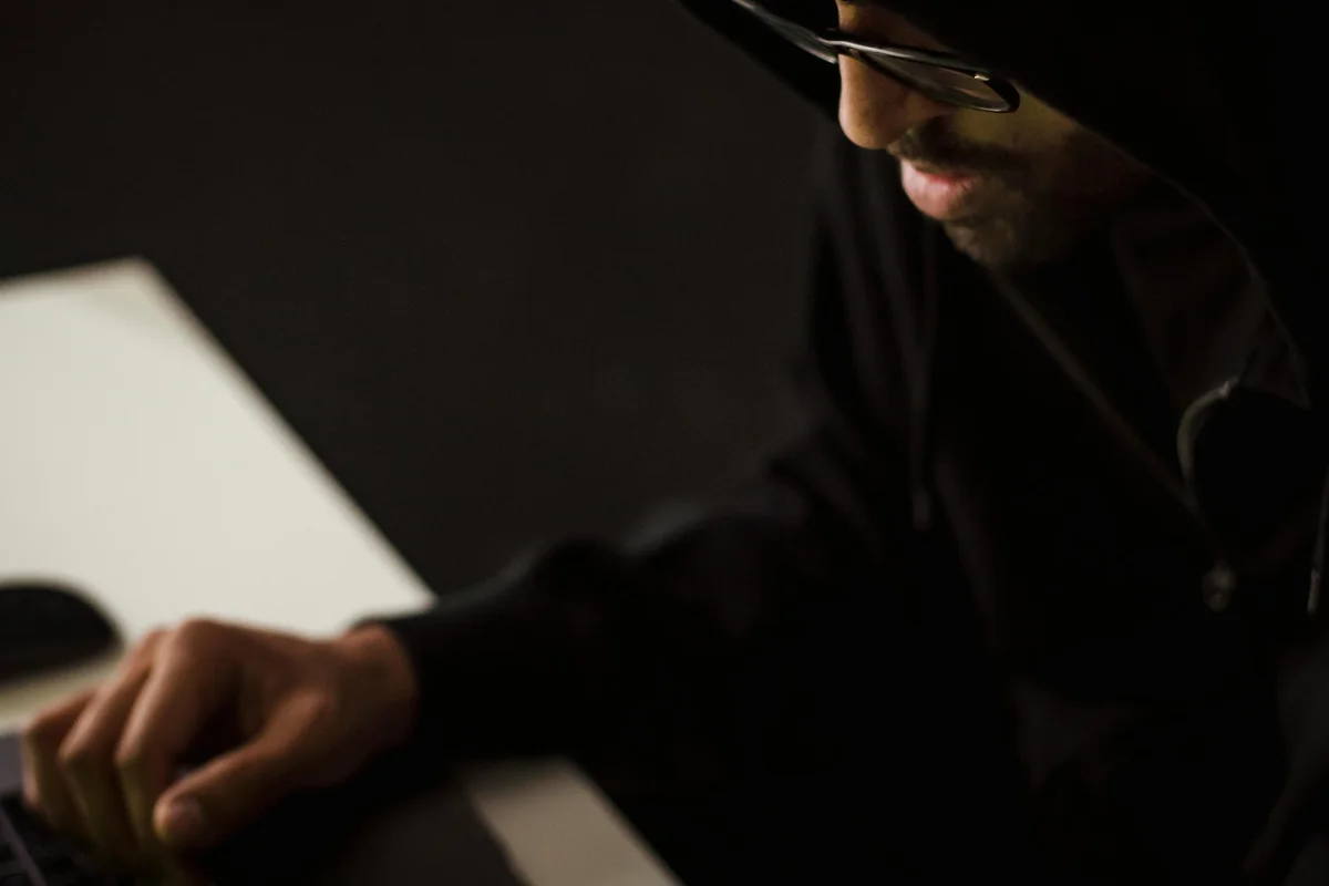 Person practicing cybersecurity skills at computer workstation